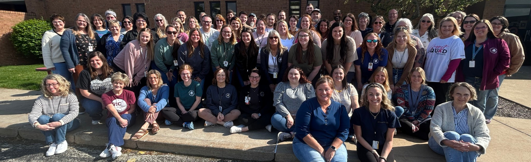 A large group of people in front of a building